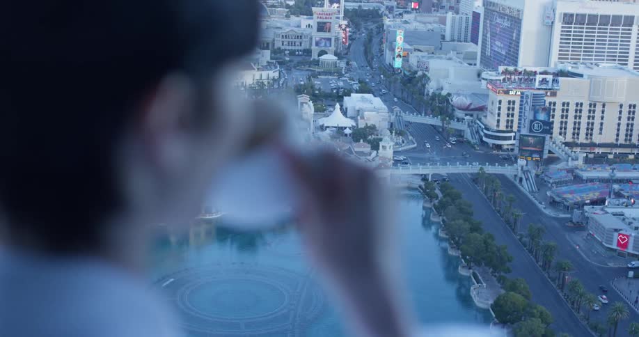 Woman sips her coffee as she looks out at the city
