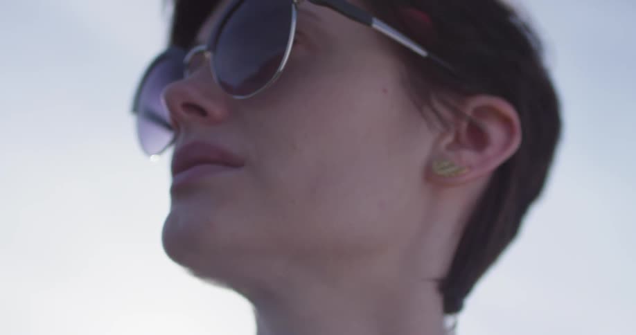 A woman wears sunglasses outside
