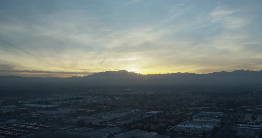 The sun sets behind a mountain