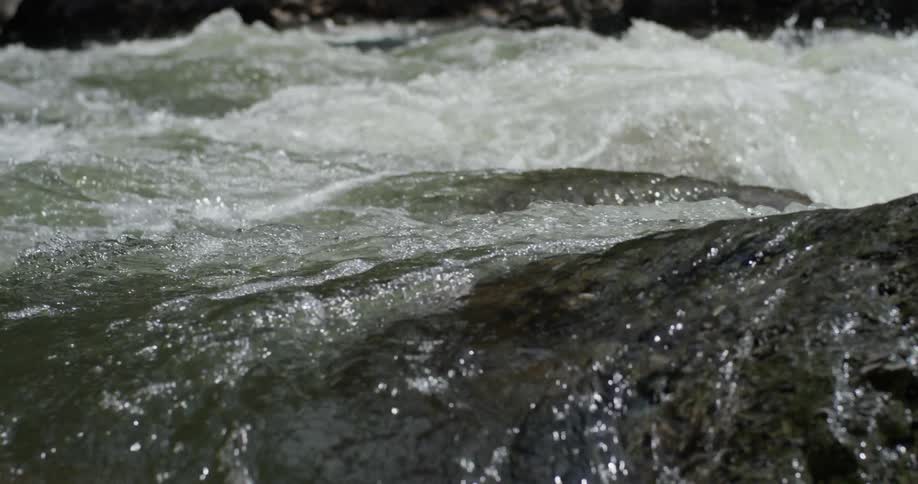 The water covers the rocks and splashes around