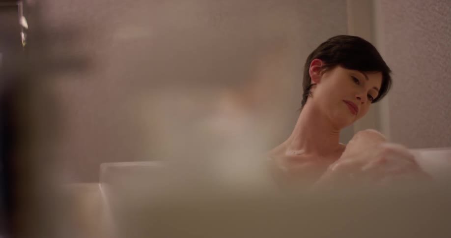 A woman is bathing in the bathroom
