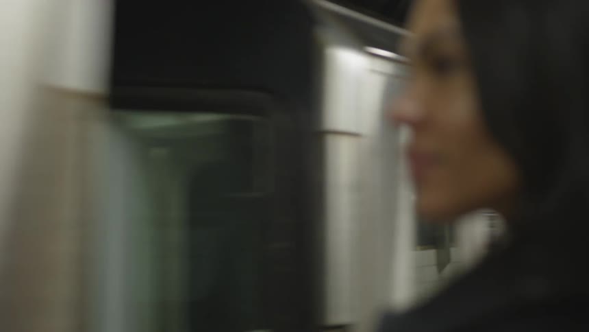 The train rides past the waiting woman