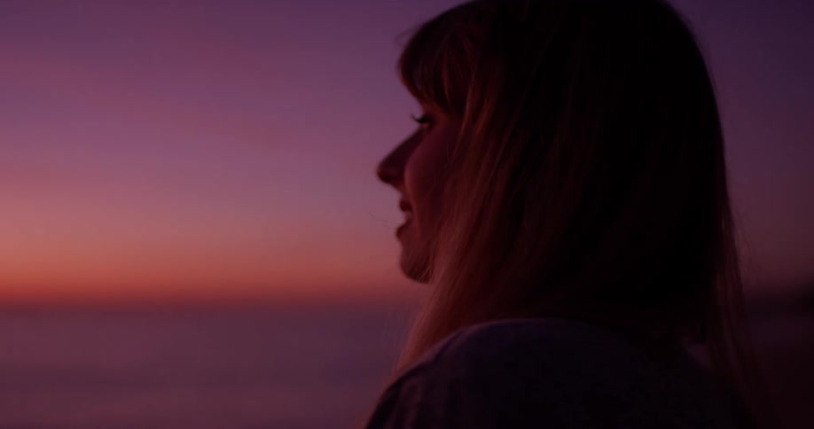 Woman Watching Sunset At Beach