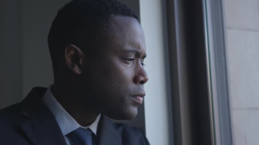 A businessman looks out a window