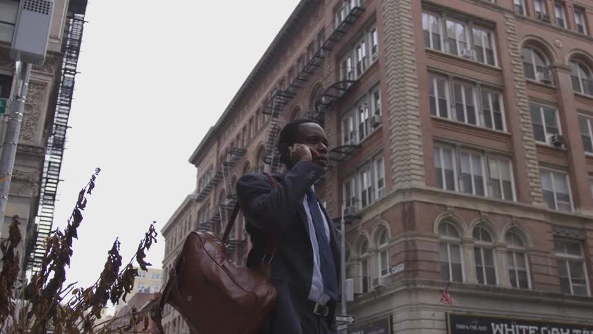 Man talks on the phone standing in the city