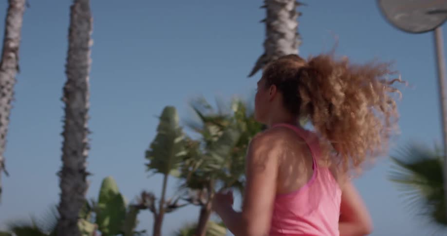 A woman jogs outside on a sunny day