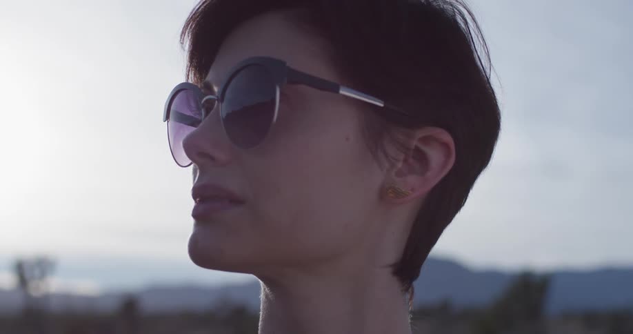 The woman is wearing large sunglasses