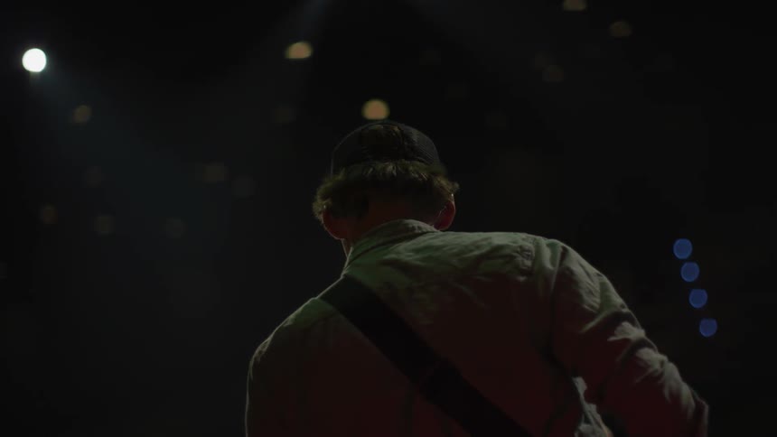 A musician performs on a stage