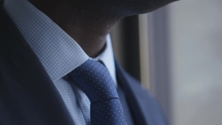 A man wears a suit and tie