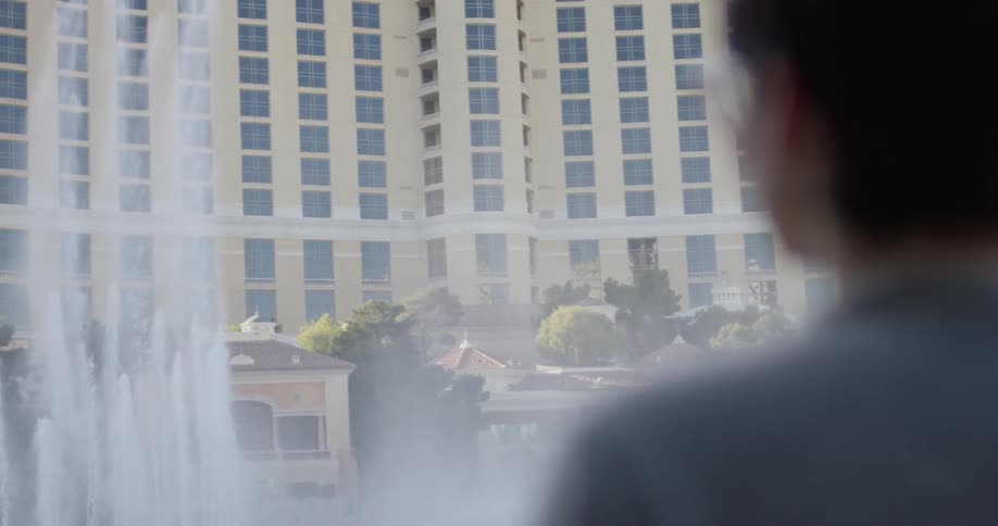 A woman watches fountains in las vegas