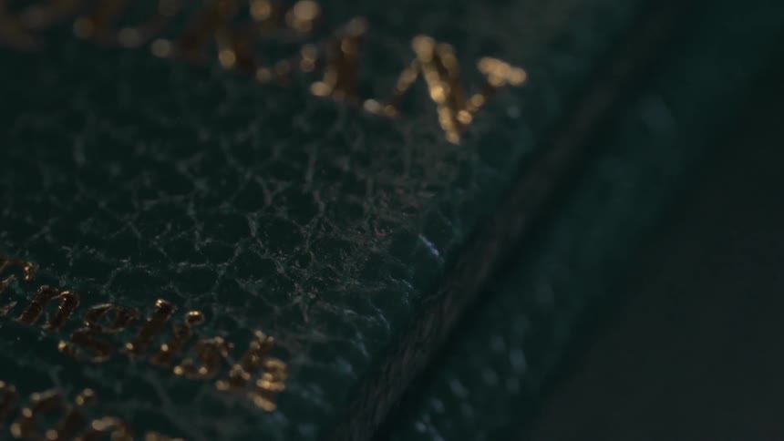 A closed copy of the quran is lying on a surface