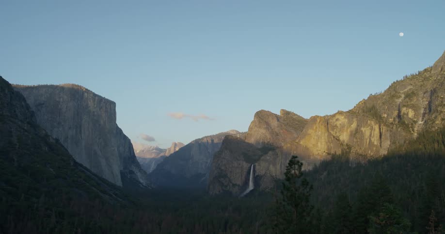 A waterfall flows over a cliff in the wilderness