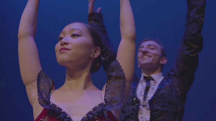 Man and woman perform a dance move