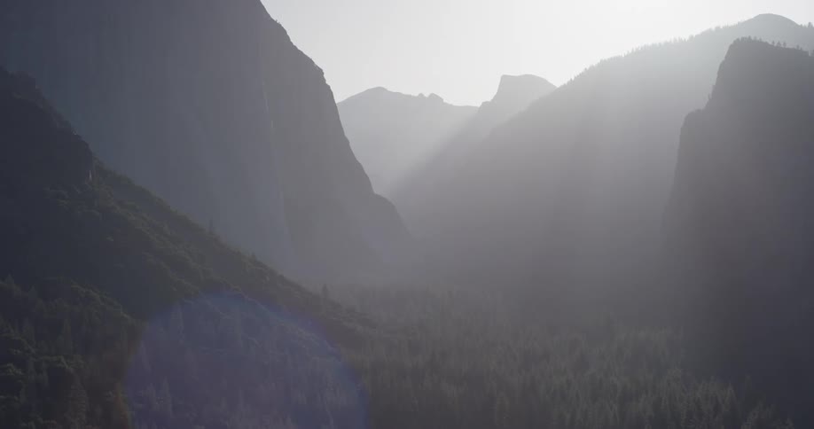 Sun shines over large rocky mountains