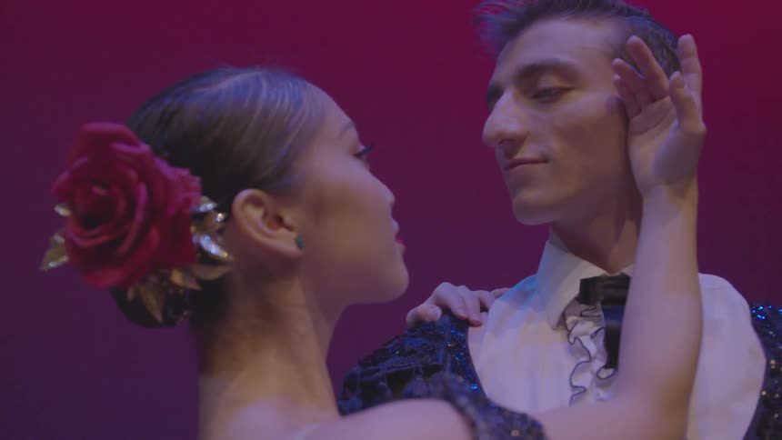 Man and woman dance together on stage
