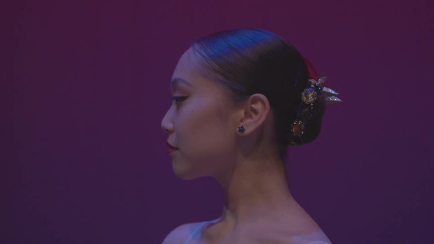 A woman looks forward blinking
