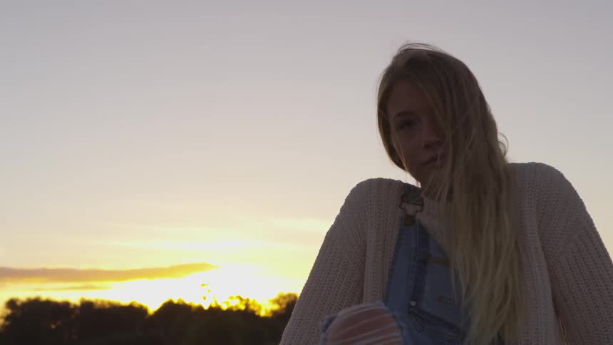 A woman blinks at dawn