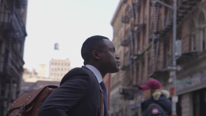 A man carries his bag in the city