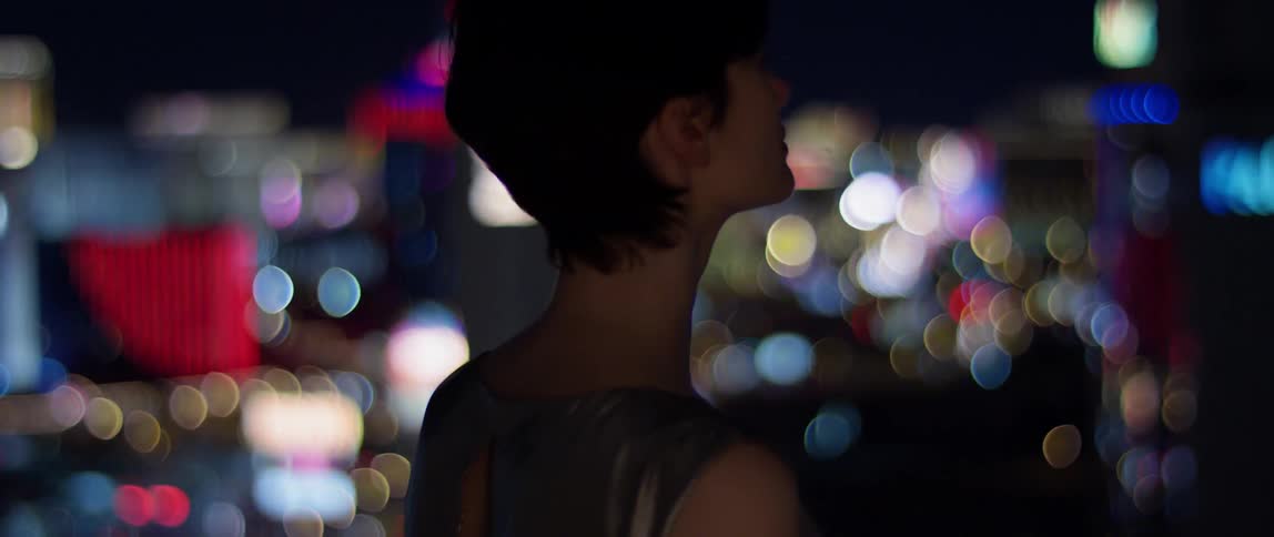 A woman is on the balcony at night