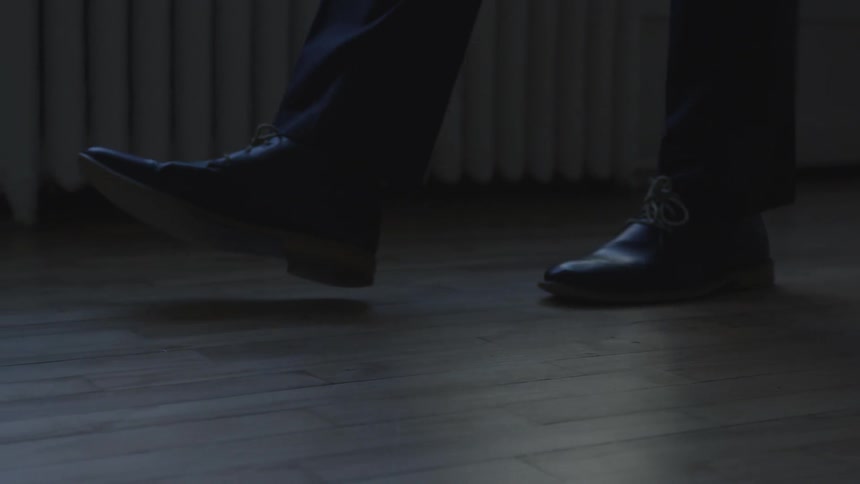 A person walks on the wood floor