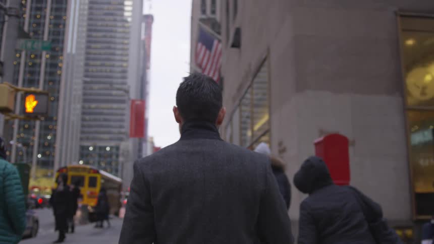 The people walk down the large city street