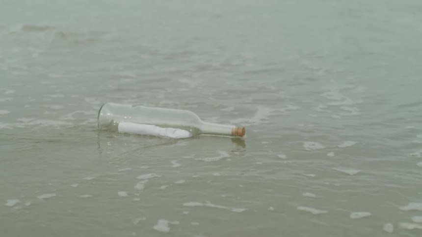 Glass bottle washes up on the beach