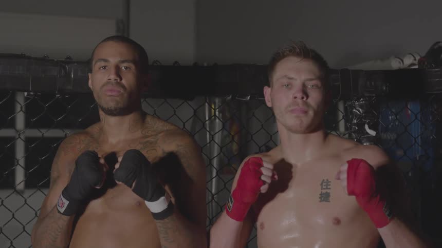 Two men stand together in the ring