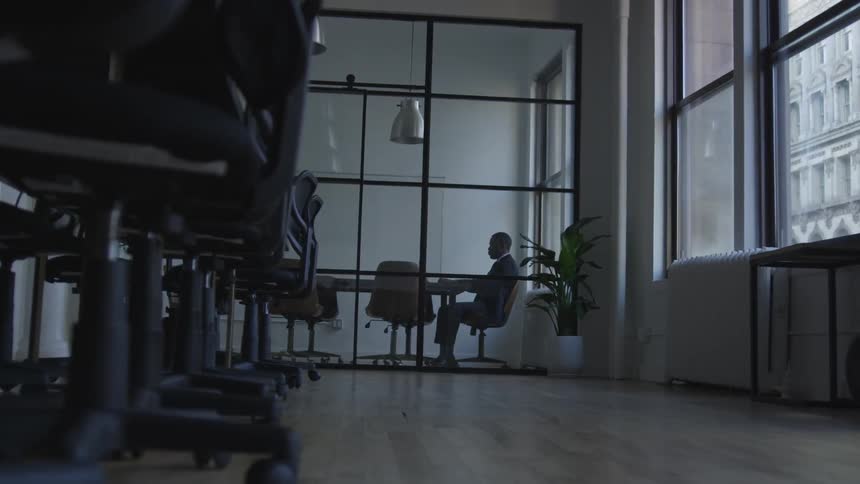 A businessman works in a conference room