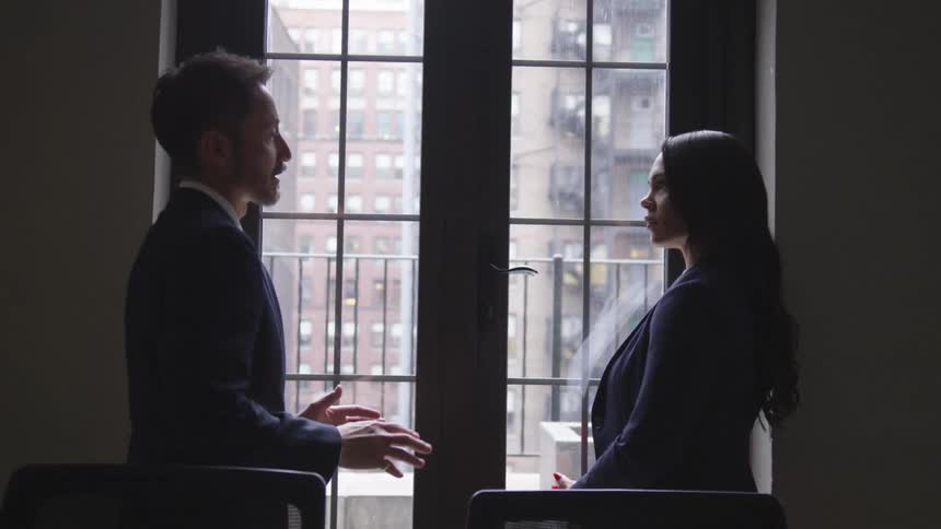 Two business professionals talk in an office