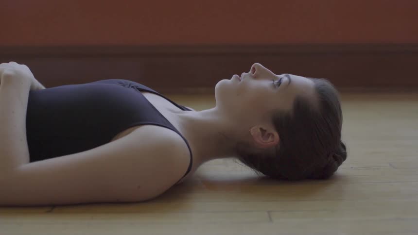 A woman lays on the wooden food