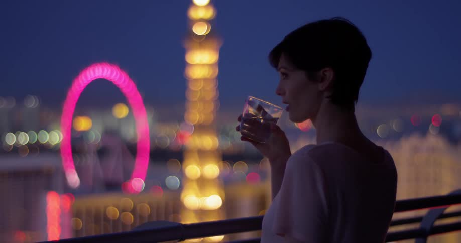 A woman enjoys a drink in las vegas at night