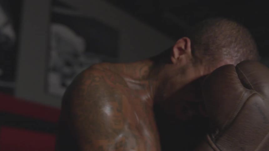 A man is getting punched with boxing gloves