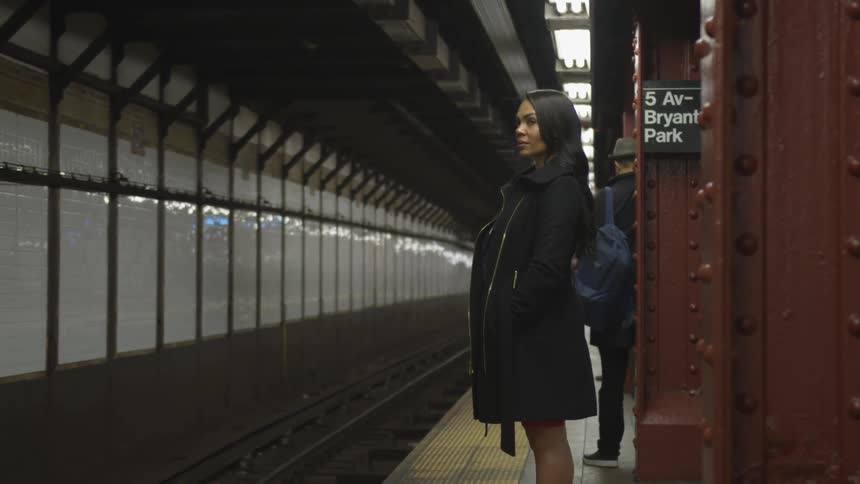 People wait for a train in the subway