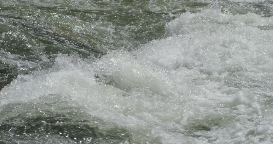 The water crashes around in the stream