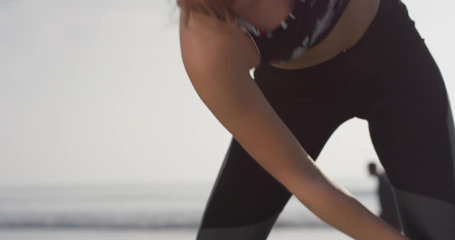 Woman stretches outside on a sunny day