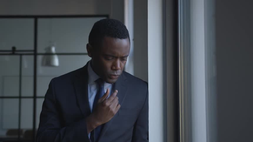 A businessman looks out a window
