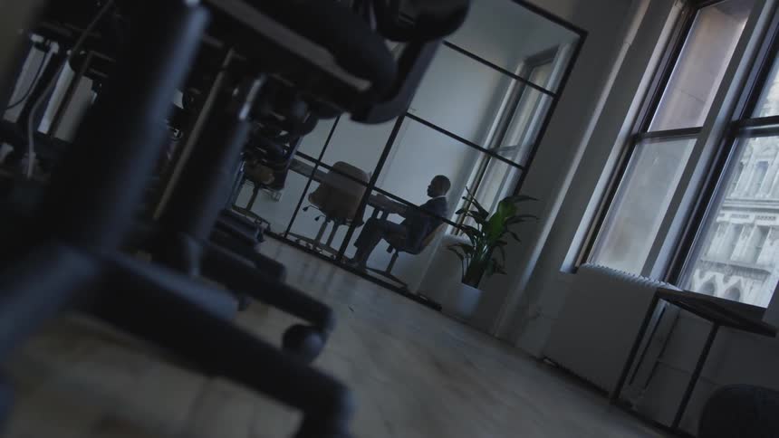 A man sits in the corner office