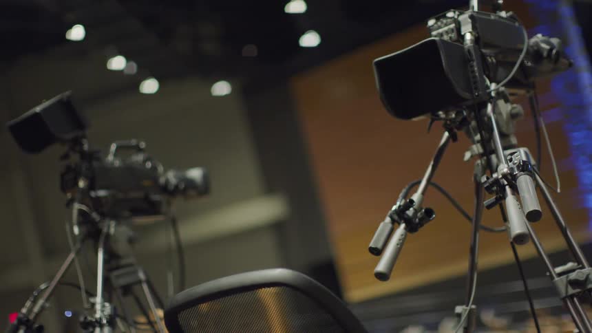 Video cameras are set up inside an auditorium