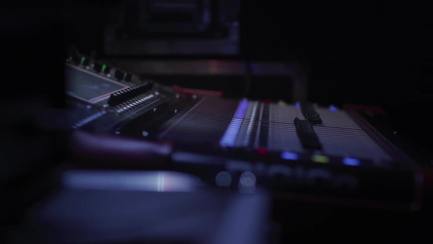 Sounds mixing equipment sits in a dark room