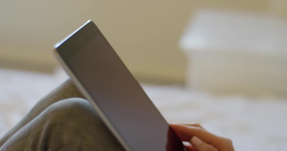 Woman Using Tablet In Apartment