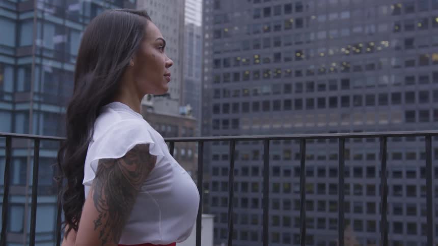 A woman looks out over the buildings