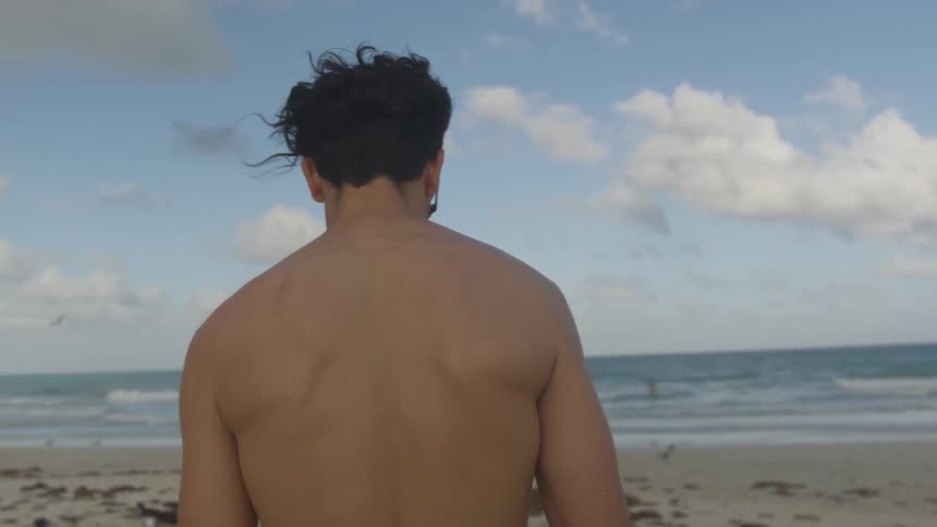 A man walks on the windy beach