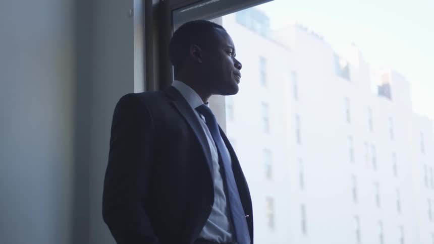A businessman looks out a window