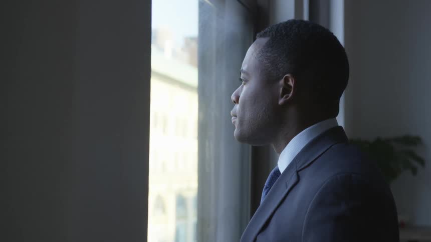 A businessman looks out a window