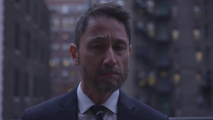 A businessman stands in a city
