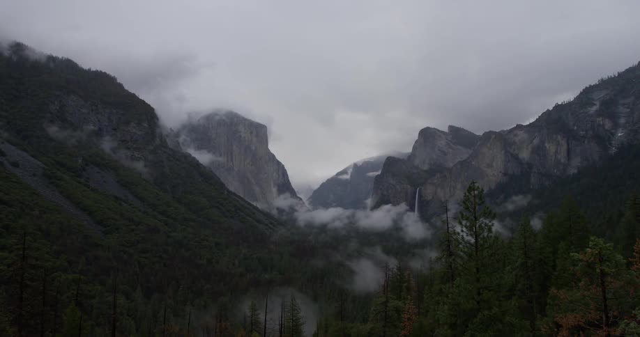 Fog billows over mountains on a cloudy day