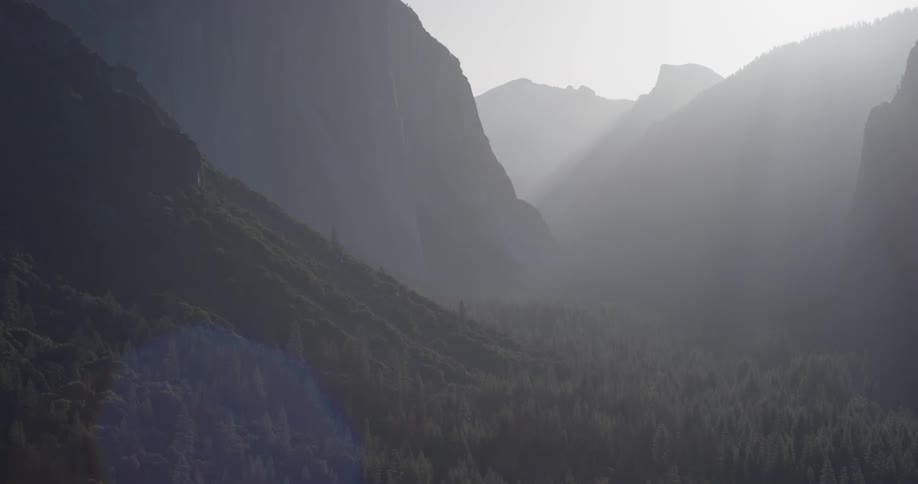 Sunlight shines over tall mountains