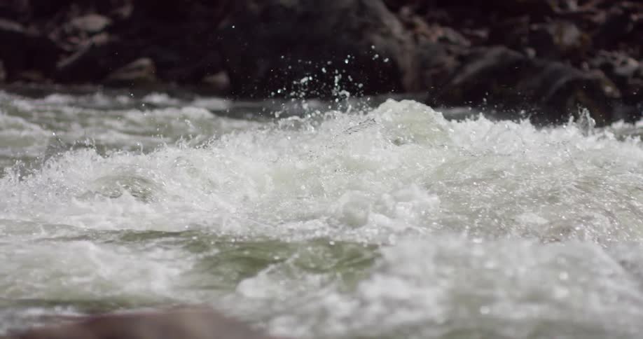 Water splashes while flowing down a river