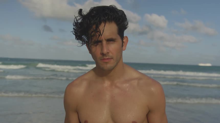 A man looks up on the beach