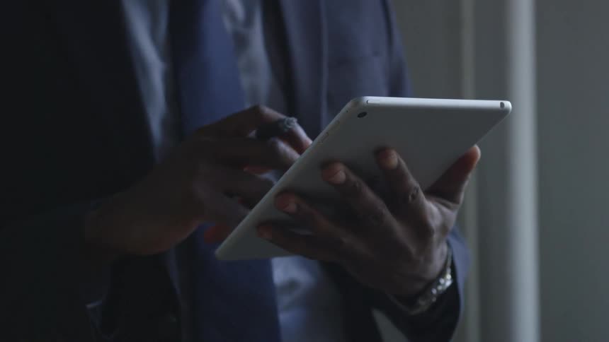 A businessman uses a tablet
